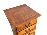a small wooden chest of drawers on a white background