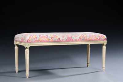 an upholstered bench with a pink and yellow floral upholstered seat