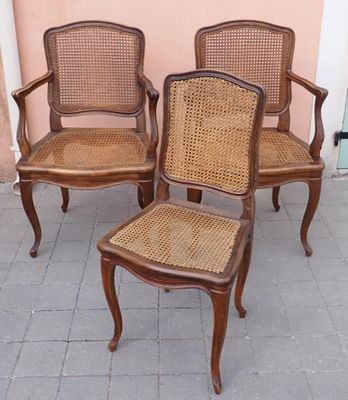 trois chaises placées les unes à côté des autres sur un trottoir