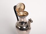 a silver vase with a handle on a white background