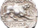 a silver coin with a lion on the front of it