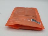 a small orange bag of food sitting on a table