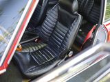 a red car with a black leather seat in the back