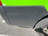 a close up of a car ' s rear end with a flat tire