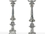 pair of antique silver candlesticks with floral designs