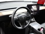 a steering wheel and dashboard of a car with a tablet on it