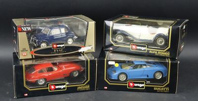 three toy cars are in boxes on a black surface