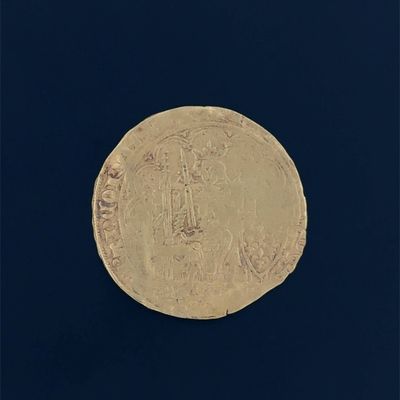 a gold coin with a picture of a man on it