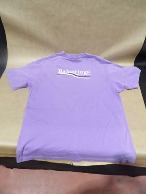 purple t - shirt with white logo on it sitting on a chair