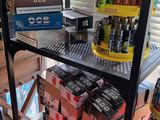 a shelf with a lot of beer on it in a store