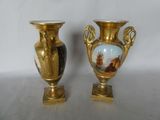 two vases that are sitting side by side on a table