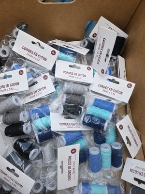 many spools of thread in a cardboard box