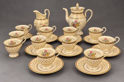 many cups and saucers that are sitting on the table