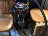 two chairs and a vacuum in a room