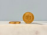 a gold coin sitting on top of a marble counter