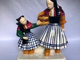 a figurine of a man and a woman holding hands