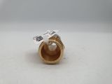 a close up of a gold ring with a pearl in it