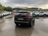 many cars parked in a parking lot on a rainy day