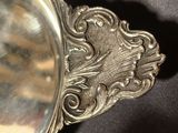 a silver plate with a decorative design on it
