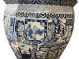a large blue and white vase sitting on a table