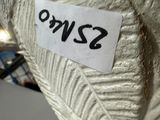 a close up of a white vase with a sticker on it
