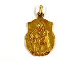 an image of a gold medal with a picture of a woman holding a baby