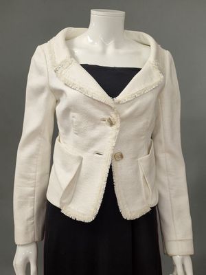 an image of a mannequin wearing a white jacket and black dress