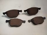 three pairs of brown brake pads on a white surface