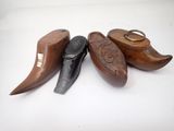 three different types of wooden shoes are lined up on a white surface