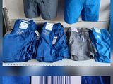 several different pictures of men ' s clothing on display in a store