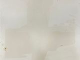 painting of a cross on a piece of paper in a white room