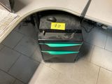 a black and green box with a yellow sticker on it