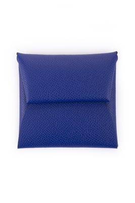 a blue leather pouch with a zipper closure on a white background