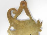 a brass ornament shaped like a goat