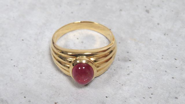 Bague en or jaune 750 millièmes, ornée au centre d'une pierre fin...