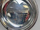 reflection of a person in a mirror of a silver plate