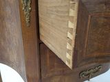 a small wooden table with a drawer on top of it