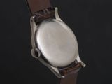 an image of a close up of a watch on a black background