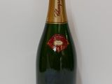an image of a bottle of champagne on a white table