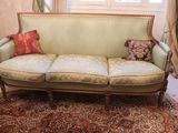 a couch that is sitting on a rug in a room