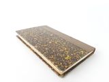 a close up of a notebook on a white surface with a white background