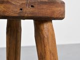 a close up of a wooden stool with a hole in the seat