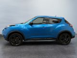 the blue nissan suv is parked in the garage