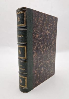 a brown book with gold trim and a black cover