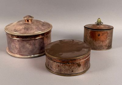 three small metal containers sitting on top of a white surface