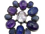 a close up of a purple and blue stone broochle