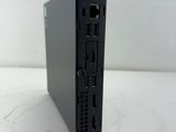 the back of a small black computer sitting on top of a white surface