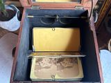 a small wooden box with two pictures inside of it