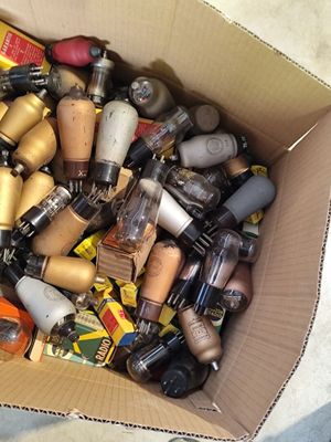 a cardboard box filled with various types of nail polishes