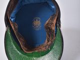a green hat with a blue patch on it
